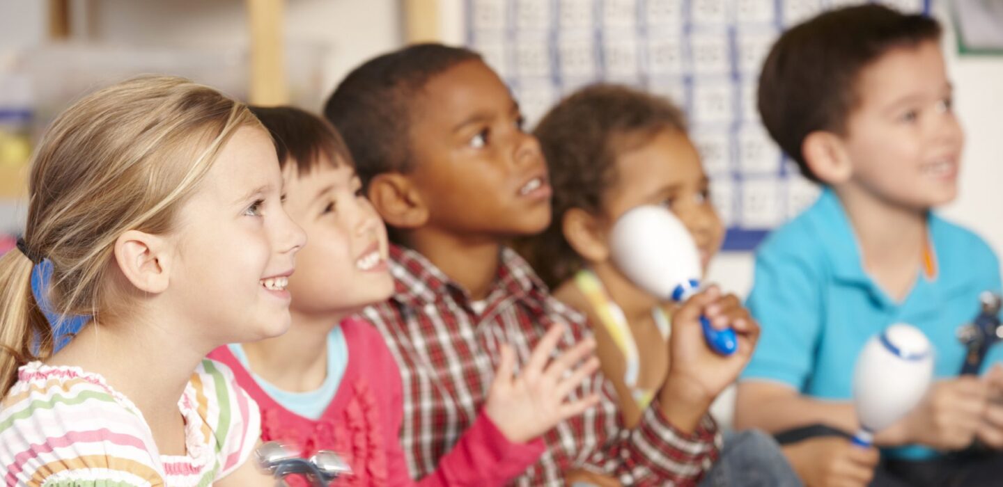 Girls and boys playing musical instruments.