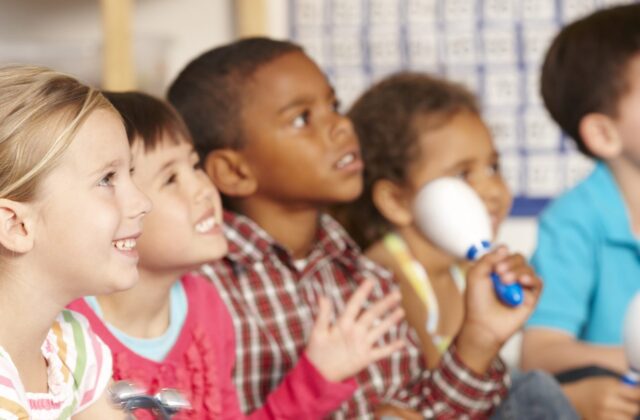 Girls and boys playing musical instruments.