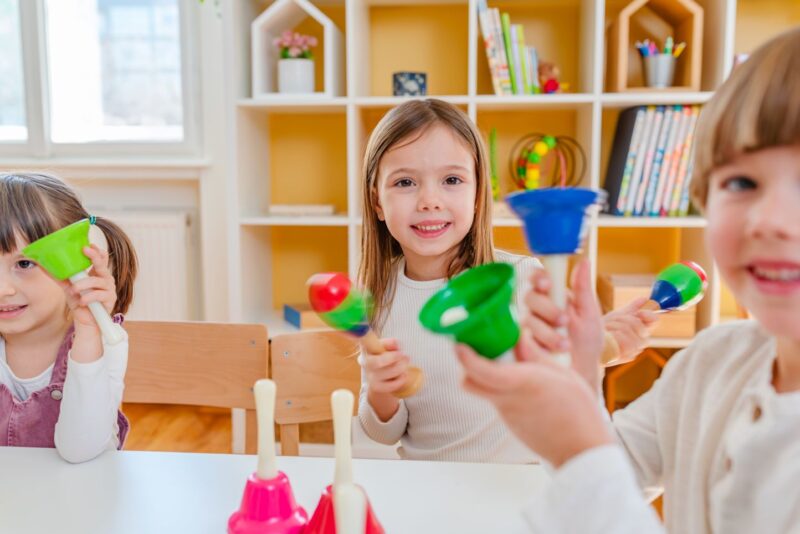 Children playing colourful bells.